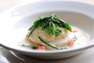 Live Cornish Crab Ravioli with Lobster & saffron bisque.